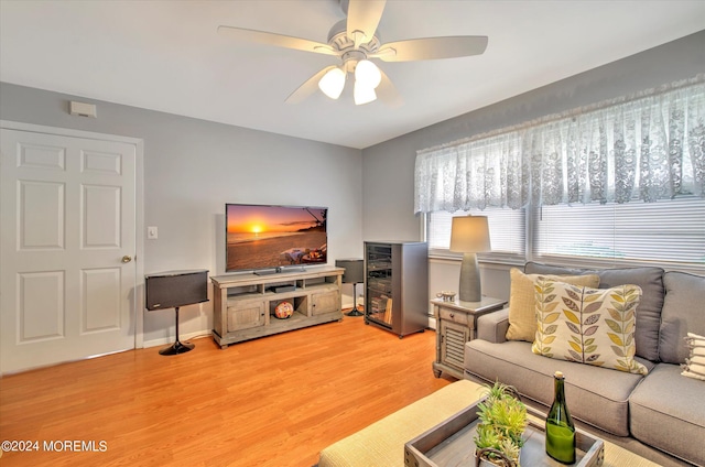 living room with ceiling fan and light hardwood / wood-style flooring