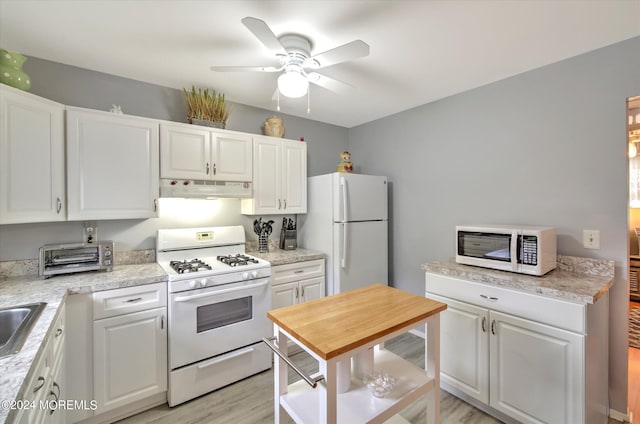 kitchen featuring white cabinets, sink, white appliances, and light hardwood / wood-style floors