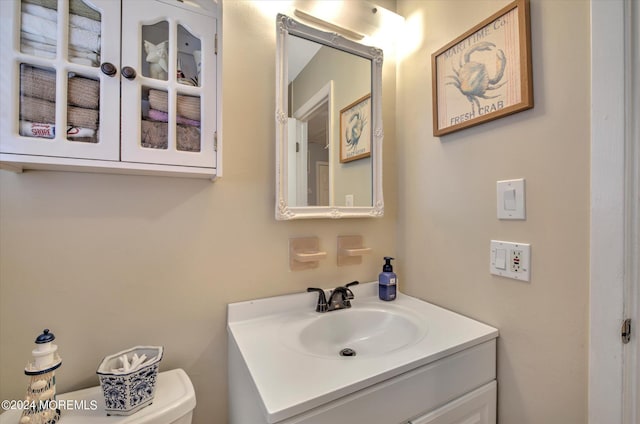 bathroom with toilet and vanity