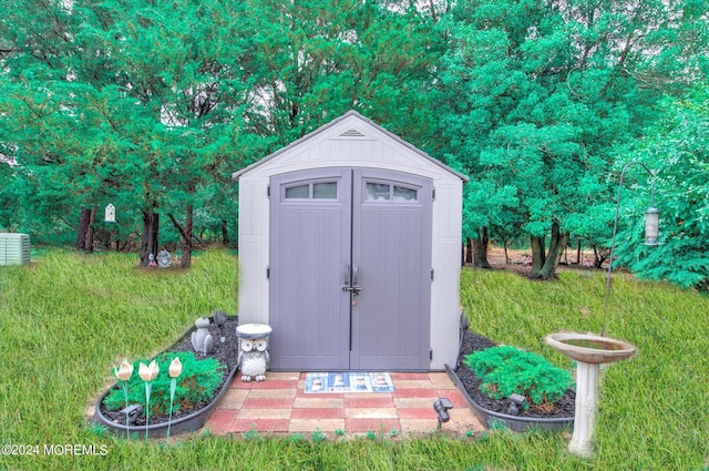 view of outbuilding with a yard