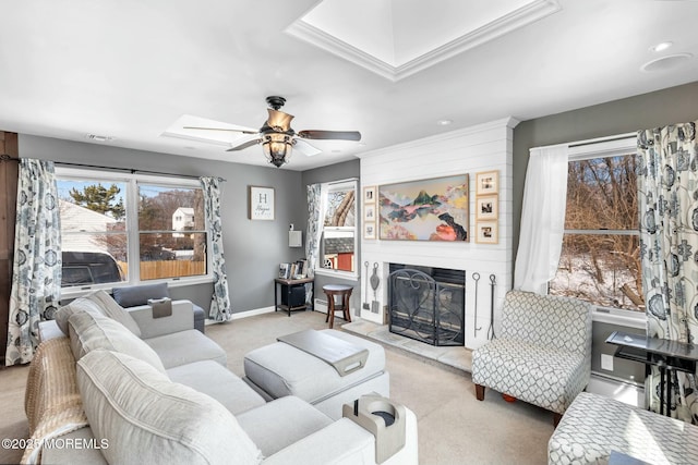 carpeted living room featuring ceiling fan and a fireplace