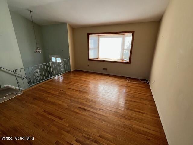 unfurnished room featuring wood-type flooring