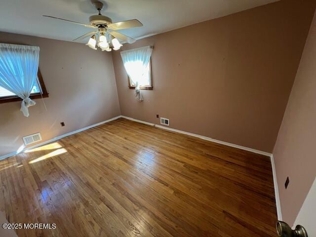 empty room featuring ceiling fan and wood-type flooring