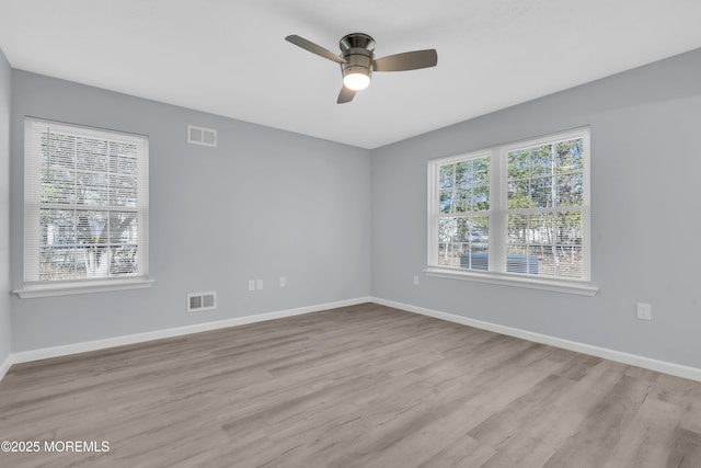 spare room with ceiling fan and light wood-type flooring