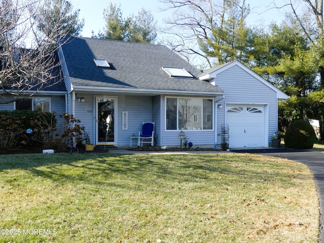 view of front of property with a garage and a front lawn