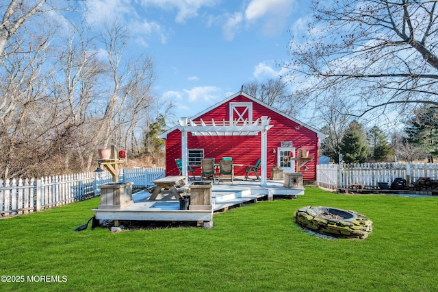 exterior space featuring a lawn, an outdoor fire pit, a pergola, and a deck