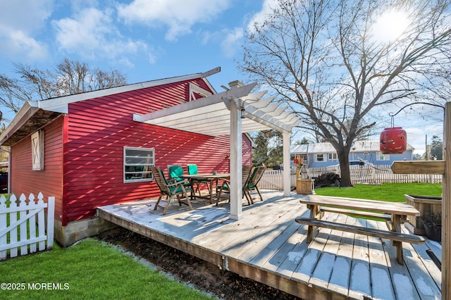 wooden deck featuring a yard and a pergola