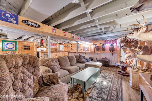 living room with hardwood / wood-style floors and wood walls