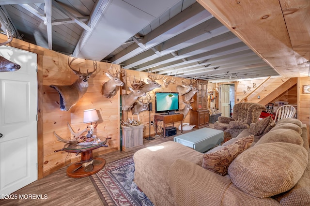 living room featuring wood-type flooring and wood walls