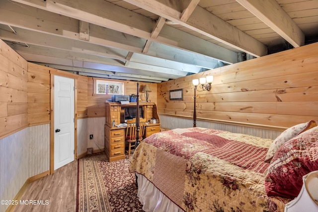 bedroom featuring light hardwood / wood-style floors and wood walls