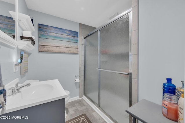 bathroom with vanity, toilet, and an enclosed shower