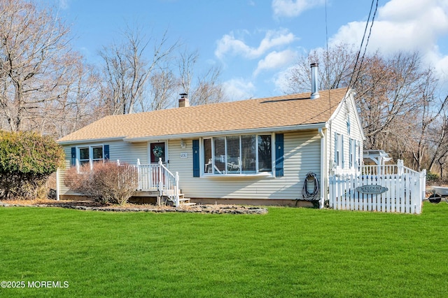 ranch-style house featuring a front yard and a deck