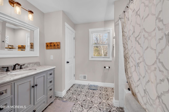 bathroom with vanity, tile patterned flooring, and shower / bath combination with curtain