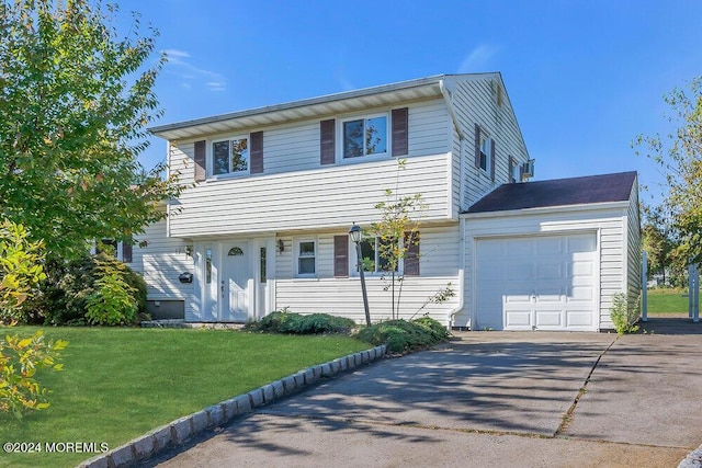 view of front of house with a front lawn and a garage