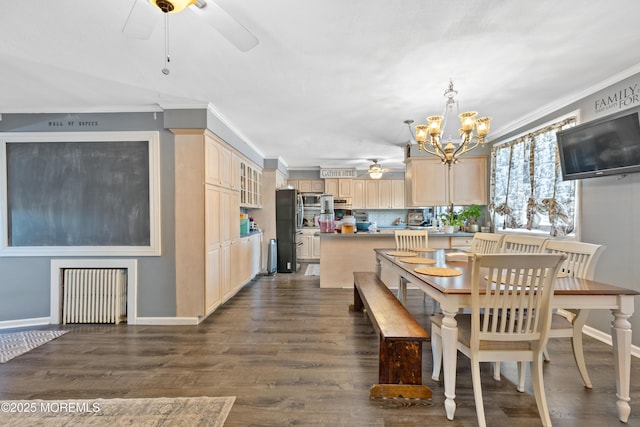 dining room featuring dark hardwood / wood-style floors, radiator, ornamental molding, and an inviting chandelier