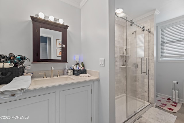 bathroom with vanity, ornamental molding, and a shower with door