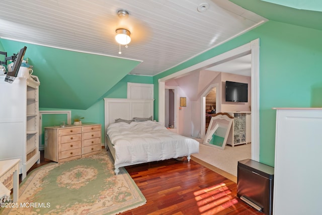 bedroom featuring vaulted ceiling and hardwood / wood-style flooring