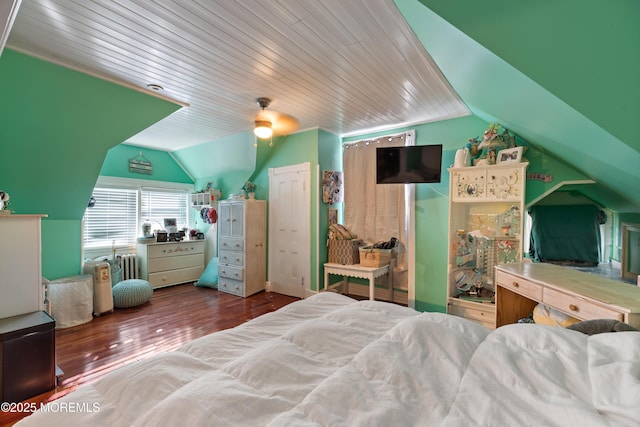 bedroom featuring lofted ceiling, ceiling fan, radiator heating unit, and hardwood / wood-style flooring