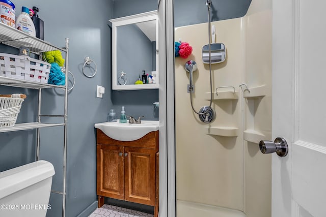 bathroom with vanity, a shower with shower door, and toilet