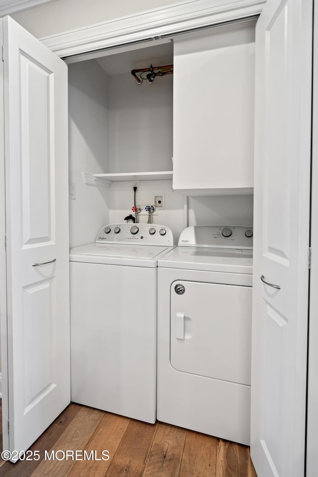 laundry room featuring separate washer and dryer and wood-type flooring