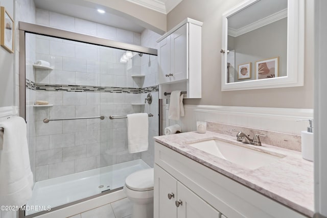 bathroom with toilet, vanity, walk in shower, crown molding, and tile patterned floors