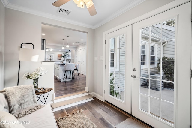 entryway with french doors, ceiling fan, crown molding, and dark hardwood / wood-style flooring