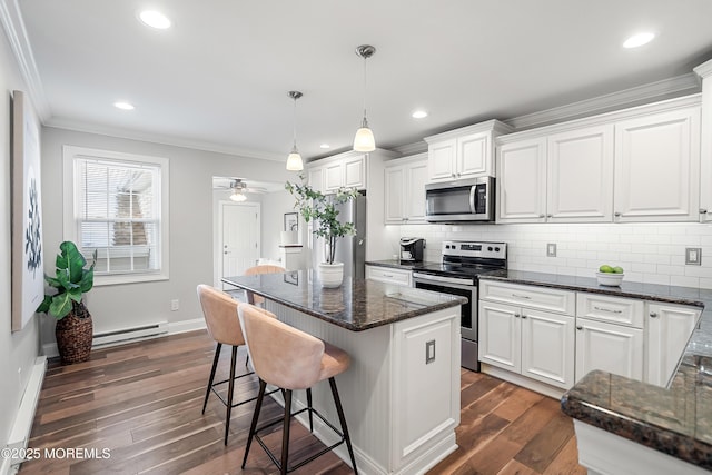 kitchen featuring a kitchen island, appliances with stainless steel finishes, white cabinets, dark hardwood / wood-style flooring, and hanging light fixtures