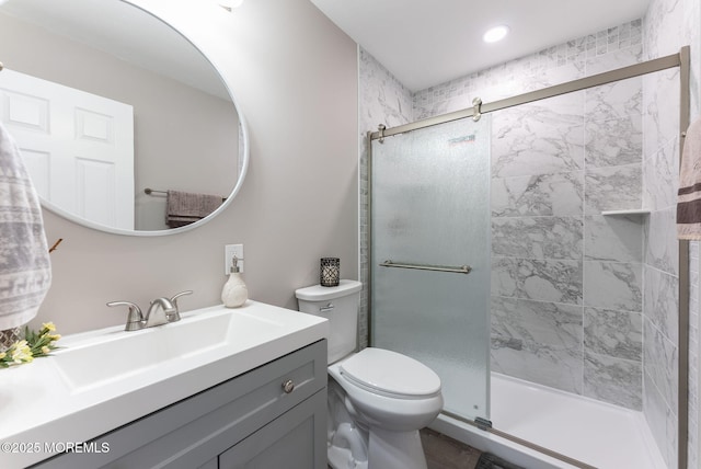 bathroom featuring vanity, toilet, and walk in shower