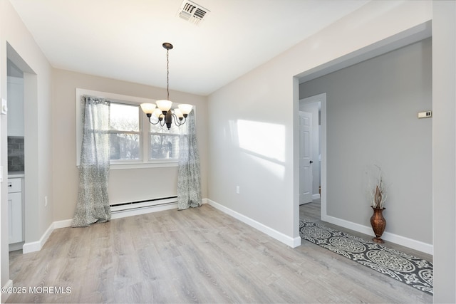 unfurnished dining area with an inviting chandelier, a baseboard radiator, and light hardwood / wood-style flooring