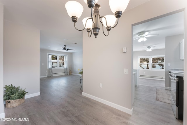 dining area featuring hardwood / wood-style flooring and ceiling fan with notable chandelier