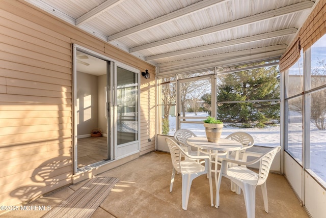 unfurnished sunroom featuring a wealth of natural light and beam ceiling