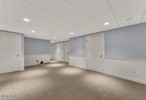 finished basement with recessed lighting, wainscoting, carpet flooring, and a drop ceiling