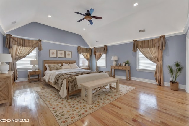 bedroom featuring lofted ceiling, light wood finished floors, multiple windows, and visible vents