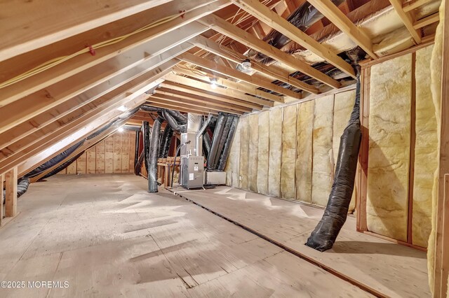 unfinished attic featuring heating unit