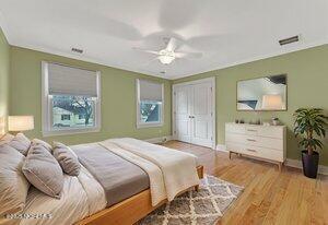 bedroom featuring a closet, visible vents, light wood-style floors, a ceiling fan, and baseboards