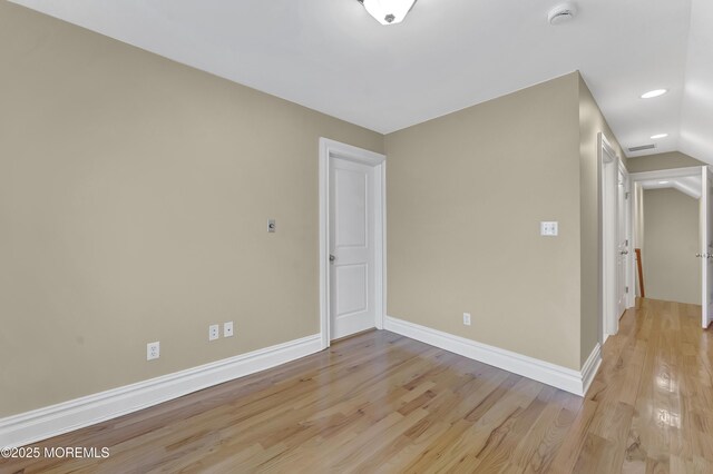 unfurnished room featuring lofted ceiling, recessed lighting, light wood-style flooring, and baseboards