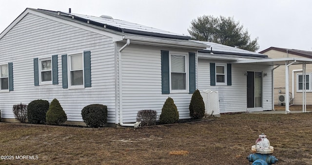 view of property exterior featuring ac unit and solar panels