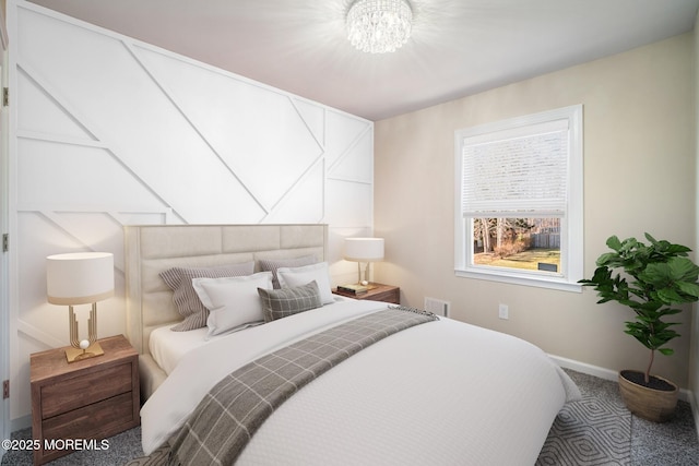 bedroom with carpet and a chandelier