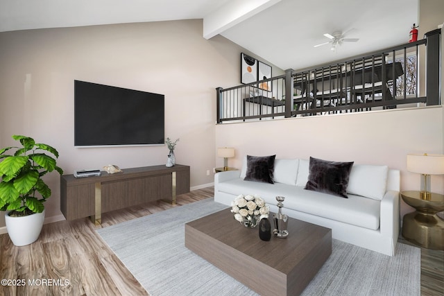 living room featuring ceiling fan, vaulted ceiling with beams, and wood-type flooring