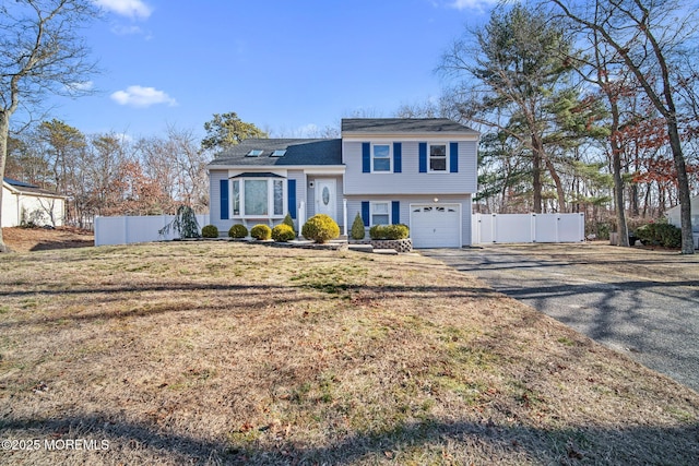 split level home featuring a front yard and a garage