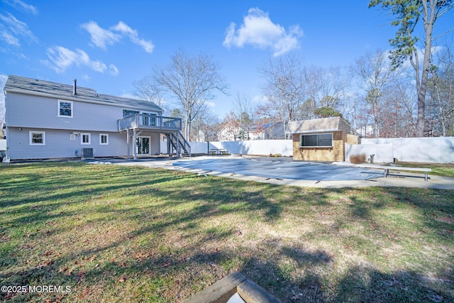 view of yard featuring a pool side deck, a storage unit, and a patio