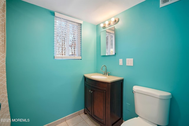 bathroom featuring tile patterned floors, toilet, and vanity