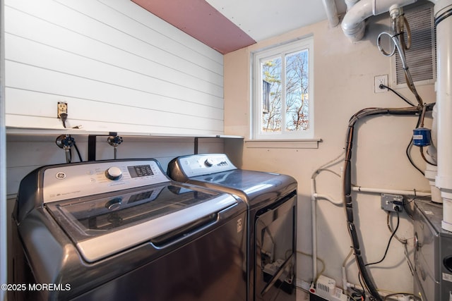 laundry area with independent washer and dryer