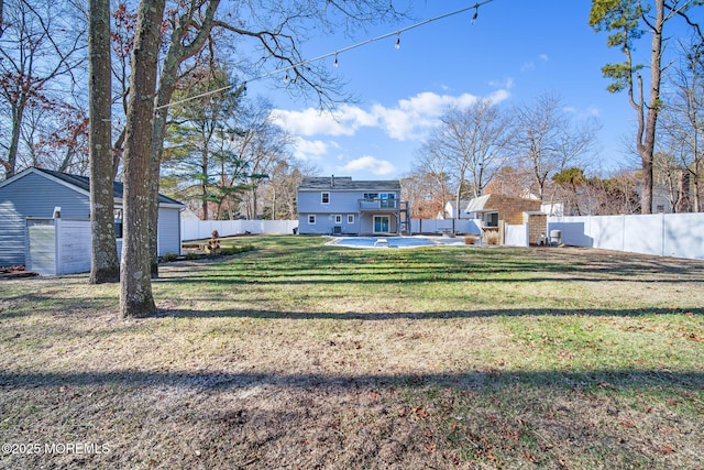 view of yard with a storage shed and a patio area