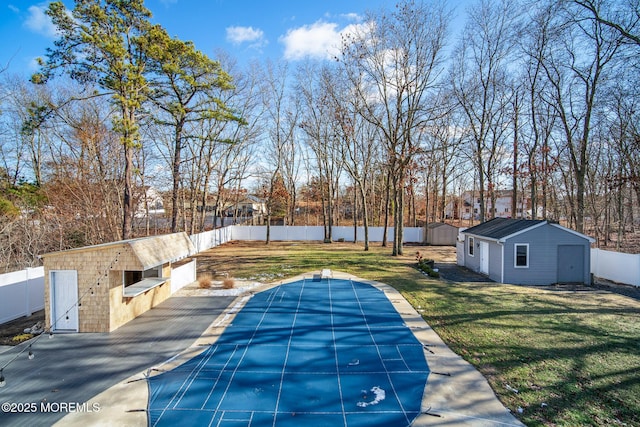 view of pool with a patio area, a storage shed, and a lawn