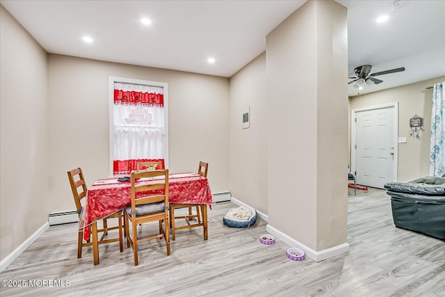 dining space featuring light wood-type flooring, a baseboard heating unit, and ceiling fan