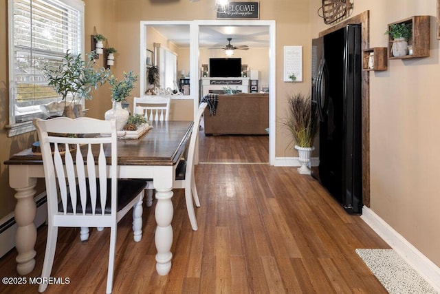 dining room with ceiling fan and wood-type flooring