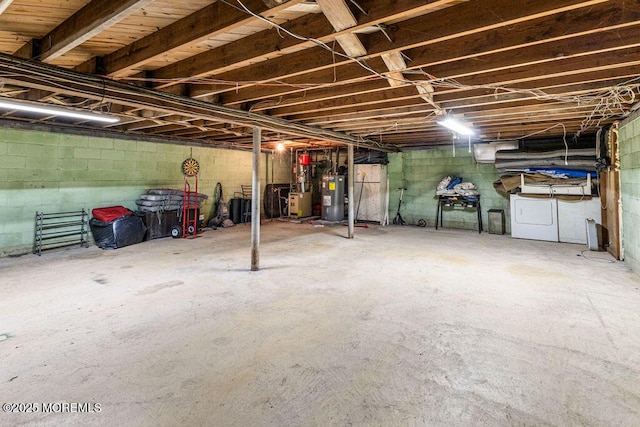 basement with water heater and washer and dryer