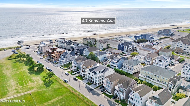 birds eye view of property featuring a water view and a view of the beach