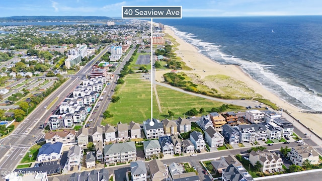 birds eye view of property with a view of the beach and a water view